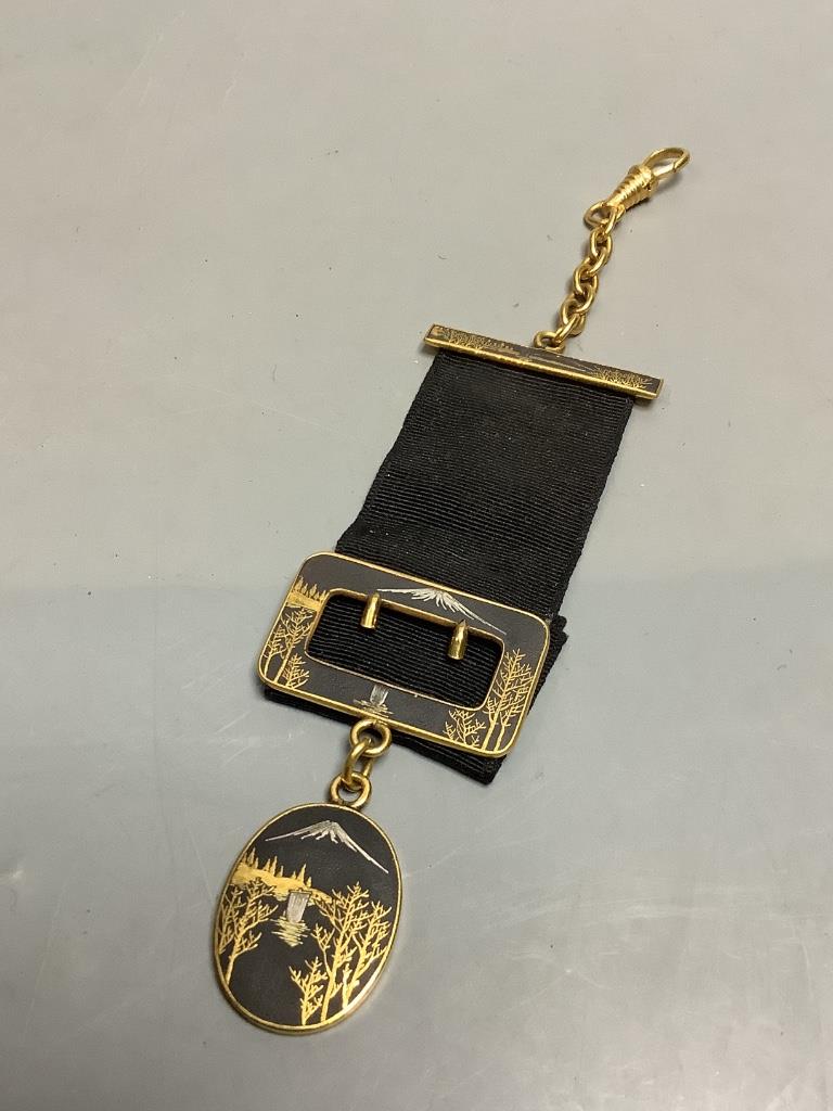 A Japanese komai style gold and silver damascened iron watch fob circa 1900
